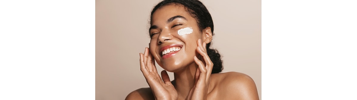 Garota aplica produtos de skincare na pele do rosto