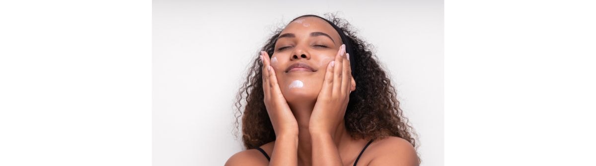 Jovem garota usa um hidratante para pele acneica no rosto