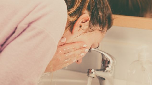 Mulher realiza a limpeza facial com o óleo de limpeza facial.